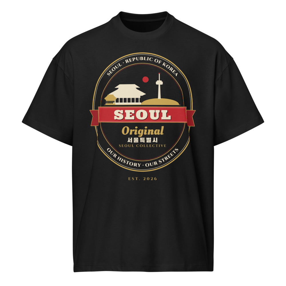 Seoul Emblem Tee, front: a gold-and-red Seoul crest with a palace gate and Namsan Tower on a black oversized tee